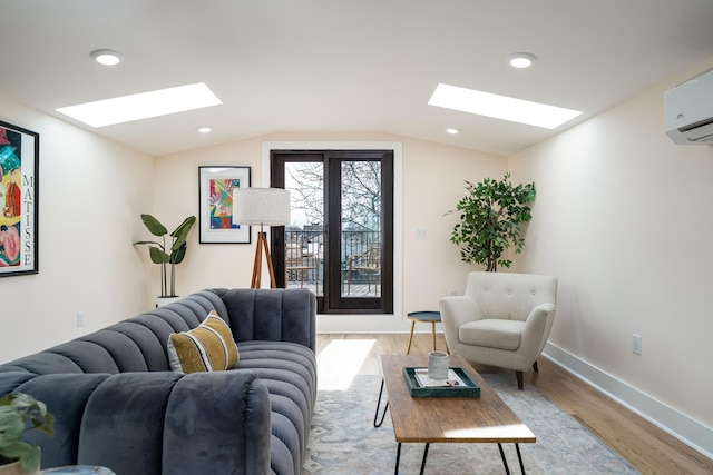 247 Harrison Ave Unit 2, Jersey City, NJ 07304 - living area with a skylight, light wood-type flooring, vaulted ceiling, an AC wall unit, and baseboards