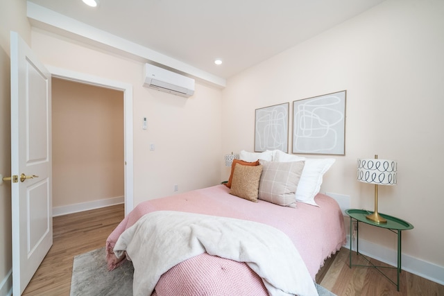 247 Harrison Ave Unit 2, Jersey City, NJ 07304 - bedroom with an AC wall unit, wood finished floors, baseboards, and recessed lighting