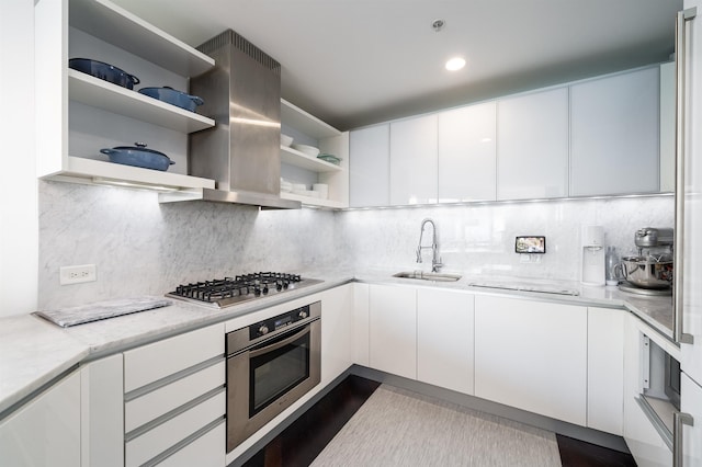 kitchen featuring stainless steel appliances, white cabinetry, tasteful backsplash, and sink