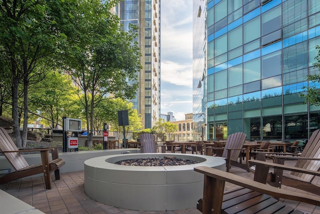 view of home's community with a patio and an outdoor fire pit