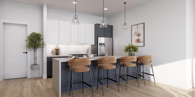 kitchen with pendant lighting, backsplash, white cabinetry, and high end fridge