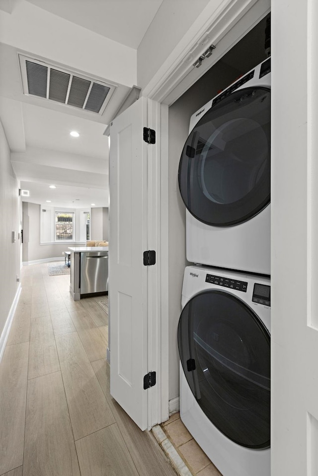 1030 Hudson St Unit 1, Hoboken, NJ 07030 - laundry area featuring stacked washer / drying machine, recessed lighting, and light wood-type flooring