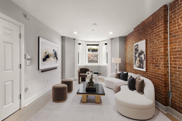 1030 Hudson St Unit 1, Hoboken, NJ 07030 - living room with wood finished floors, brick wall, baseboards, and recessed lighting