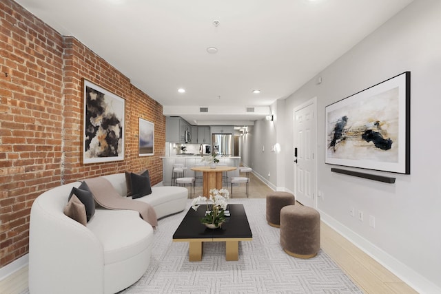 1030 Hudson St Unit 1, Hoboken, NJ 07030 - living room with baseboards, light wood-style floors, brick wall, and recessed lighting
