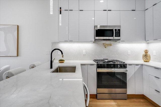 177 Wilkinson Ave Unit 1, Jersey City, NJ 07305 - kitchen featuring a sink, modern cabinets, white cabinetry, and stainless steel appliances