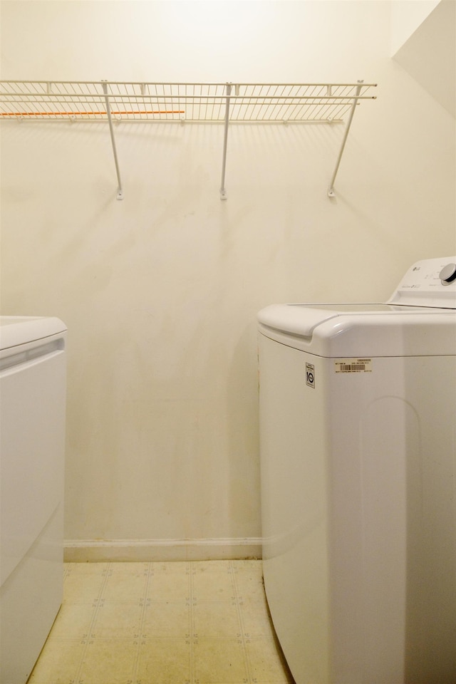 111 Watson Ct, Howell Township, NJ 07731 - clothes washing area featuring washer and dryer, tile patterned floors, and baseboards