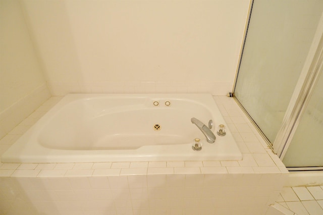 full bath with a tub with jets