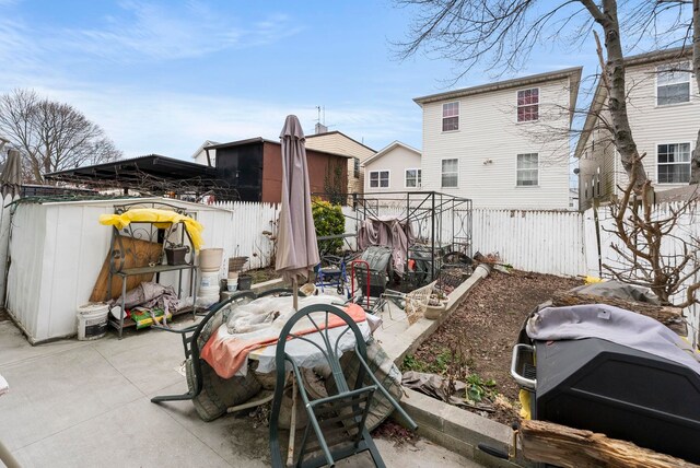57 Wegman Pkwy, Jersey City, NJ 07305 - back of property featuring a fenced backyard and a patio area