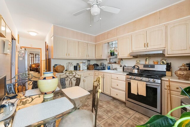 57 Wegman Pkwy, Jersey City, NJ 07305 - kitchen featuring stainless steel range with gas stovetop, ceiling fan, a sink, light countertops, and under cabinet range hood