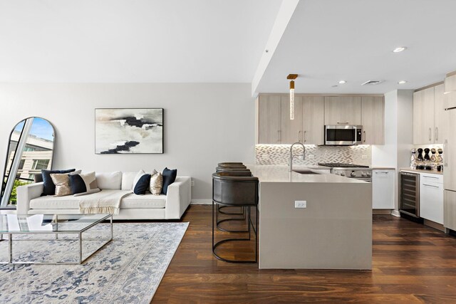 1200 Avenue At Port Imperial Unit 305, Weehawken, NJ 07086 - kitchen with stainless steel microwave, beverage cooler, a sink, modern cabinets, and a kitchen breakfast bar