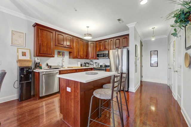 20 Avenue At Port Imperial Unit 425, West New York, NJ 07093 - kitchen with appliances with stainless steel finishes, a center island, light countertops, a kitchen bar, and dark wood-type flooring
