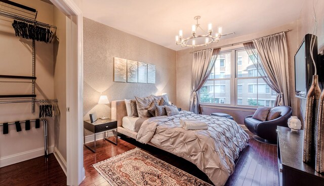 bedroom featuring a closet, a notable chandelier, and dark hardwood / wood-style floors