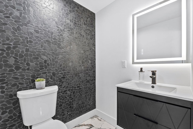 63 Jefferson Ave Unit 2, Jersey City, NJ 07307 - half bathroom with marble look tiles, toilet, vanity, and baseboards