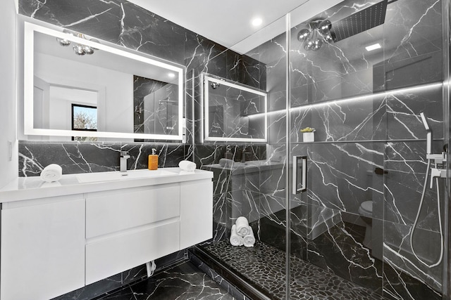 63 Jefferson Ave Unit 2, Jersey City, NJ 07307 - bathroom with marble tiled flooring, a marble finish shower, vanity, tile walls, and recessed lighting