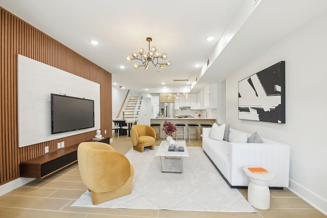 living room with stairway, a notable chandelier, recessed lighting, and baseboards