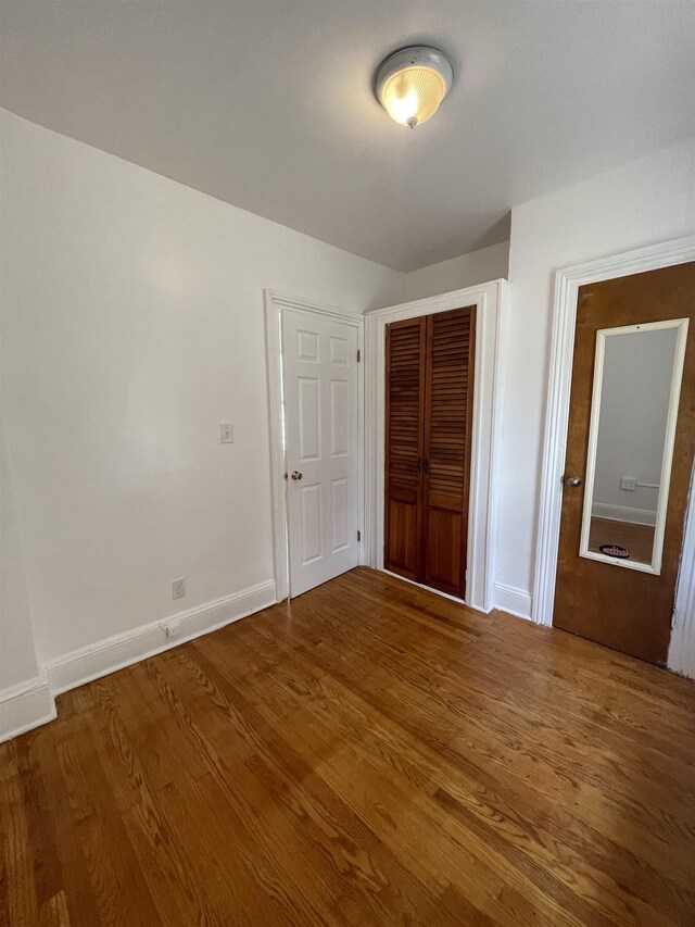 31 E 32nd St, Bayonne, NJ 07002 - unfurnished bedroom featuring a closet, baseboards, and wood finished floors