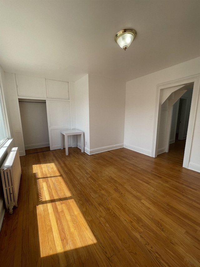 31 E 32nd St, Bayonne, NJ 07002 - unfurnished dining area with radiator heating unit, wood finished floors, and baseboards