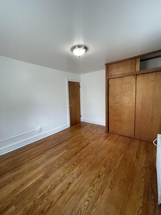 31 E 32nd St, Bayonne, NJ 07002 - unfurnished bedroom featuring wood finished floors, a closet, and baseboards