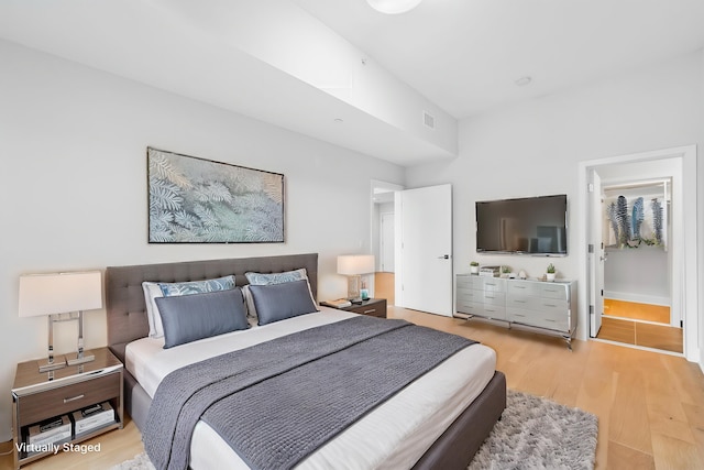 bedroom featuring light wood-type flooring and visible vents