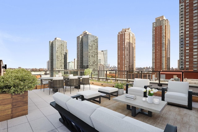 view of patio with a view of city, outdoor dining area, and an outdoor hangout area