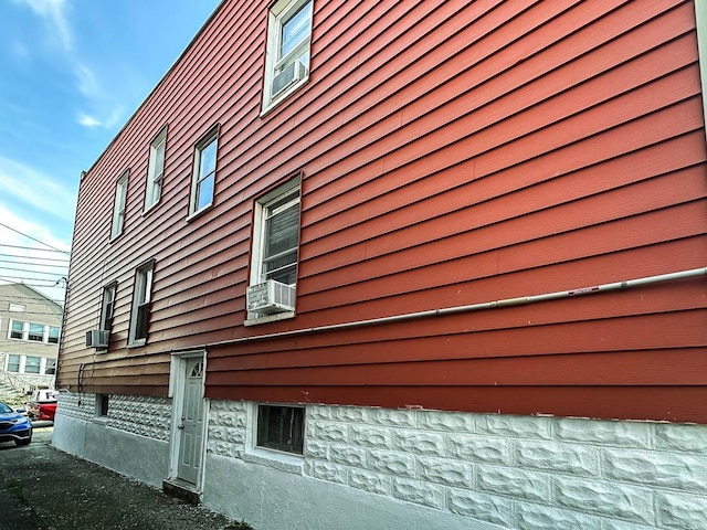 view of side of property with cooling unit