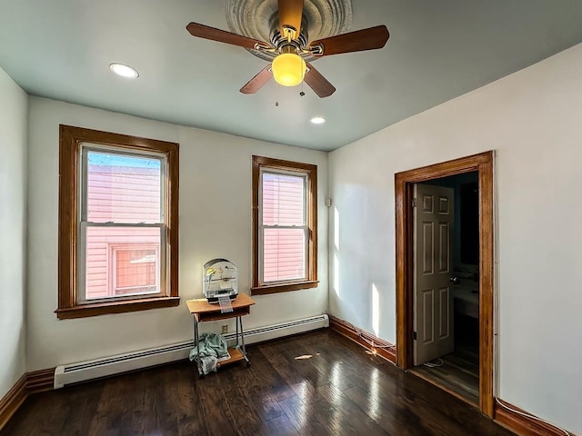 spare room featuring ceiling fan and dark hardwood / wood-style floors