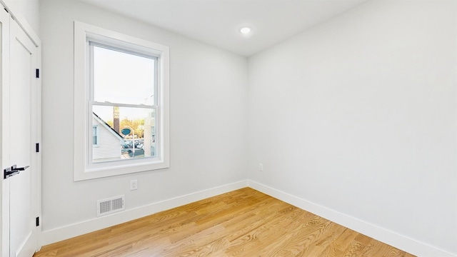 unfurnished room with light wood-type flooring, visible vents, baseboards, and recessed lighting