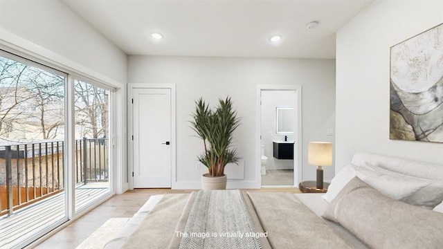 bedroom with light wood-type flooring, access to outside, ensuite bath, and recessed lighting