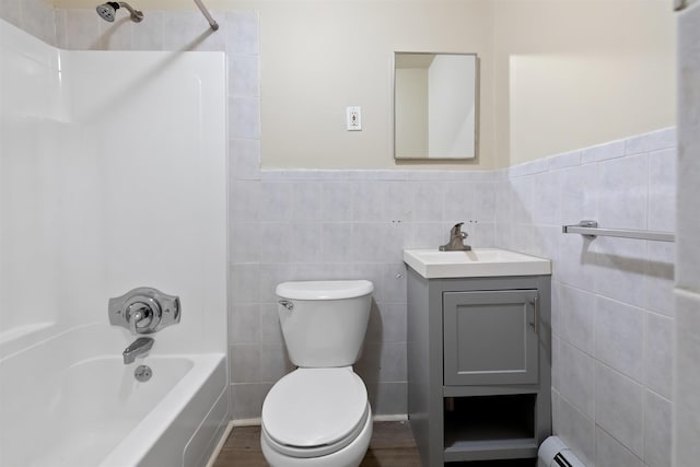 full bathroom featuring baseboard heating, vanity, toilet, shower / washtub combination, and tile walls