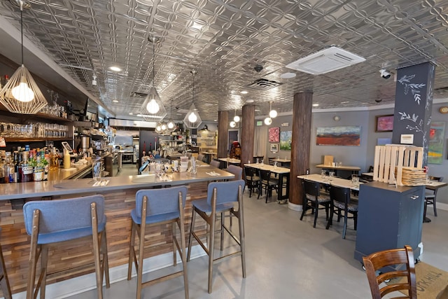 bar featuring wet bar, concrete flooring, and an ornate ceiling