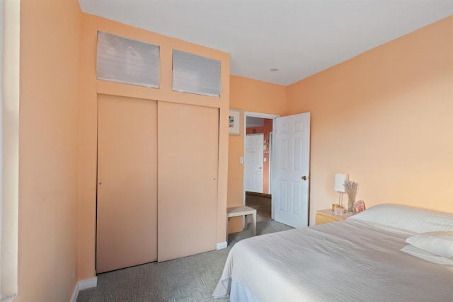 bedroom with a closet, carpet, and baseboards