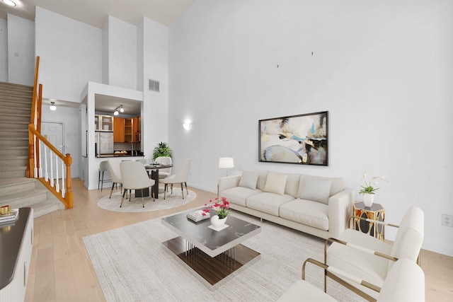 26 Ave At Port Imperial Unit 440, West New York, NJ 07093 - living room with stairs, high vaulted ceiling, and wood finished floors
