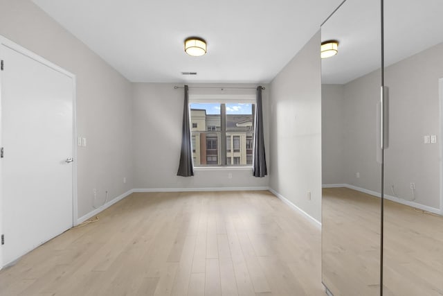 26 Ave At Port Imperial Unit 440, West New York, NJ 07093 - spare room featuring baseboards and light wood-style flooring