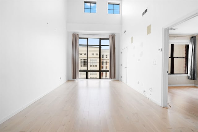26 Ave At Port Imperial Unit 440, West New York, NJ 07093 - empty room with light wood-type flooring, plenty of natural light, and a high ceiling