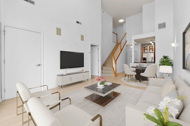 26 Ave At Port Imperial Unit 440, West New York, NJ 07093 - living room featuring a towering ceiling and stairway