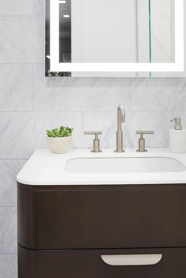 bathroom with vanity and decorative backsplash