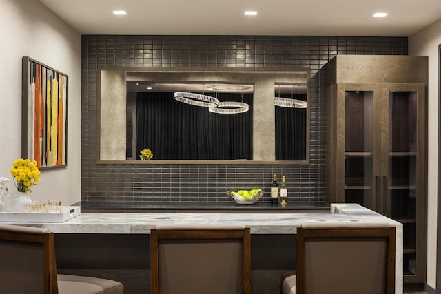 bar featuring tasteful backsplash and recessed lighting