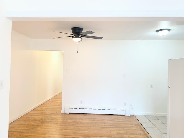 1518 38th St, North Bergen, NJ 07047 - empty room with a baseboard heating unit, ceiling fan, light wood-style floors, and baseboards