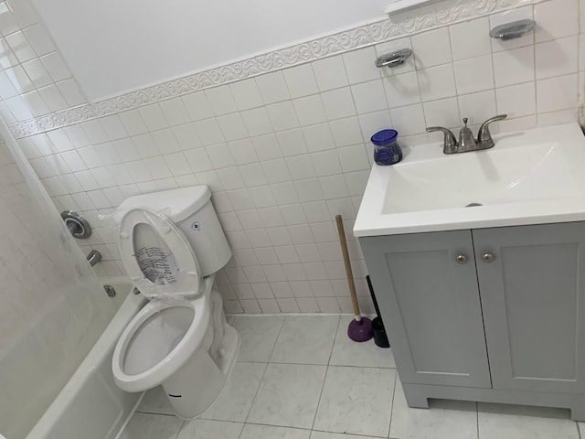 1518 38th St, North Bergen, NJ 07047 - bathroom with tile walls, vanity, toilet, tile patterned floors, and washtub / shower combination
