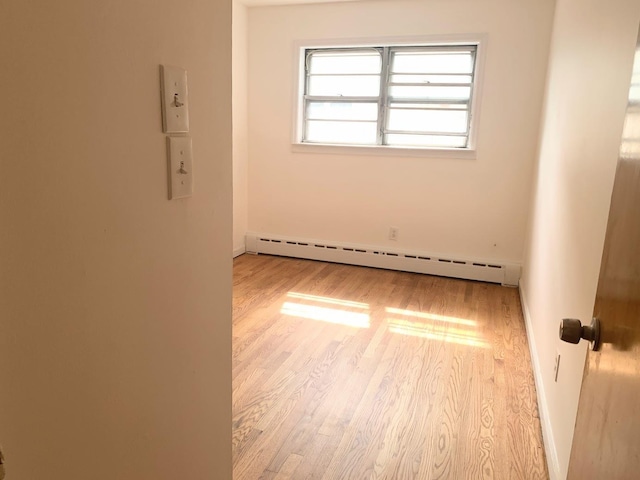1518 38th St, North Bergen, NJ 07047 - spare room with a baseboard radiator, wood finished floors, and baseboards