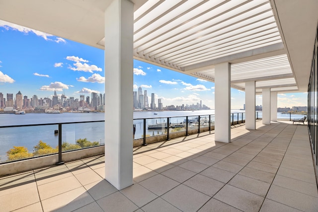 view of patio / terrace with a water view and a balcony