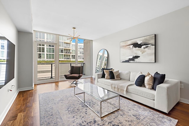 living room with dark hardwood / wood-style flooring and an inviting chandelier