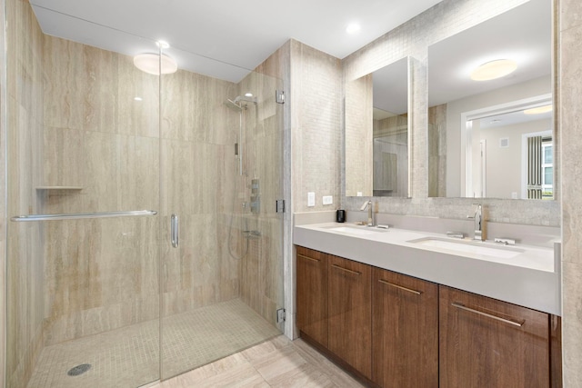 bathroom with tile patterned flooring, an enclosed shower, and vanity