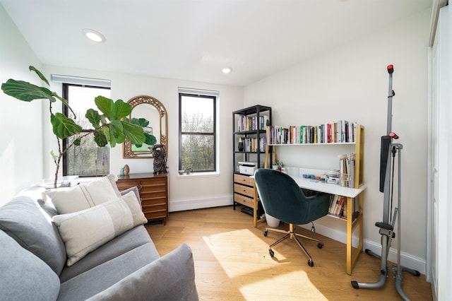 office space featuring recessed lighting, baseboards, wood finished floors, and plenty of natural light