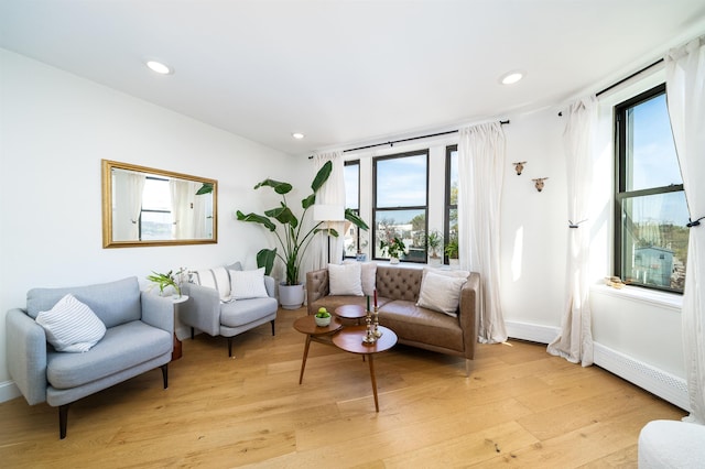 living area featuring light wood-style floors, recessed lighting, and baseboards