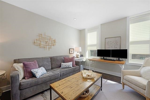 living room with baseboards and wood finished floors