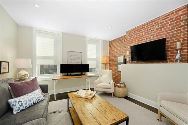 living area with recessed lighting, baseboards, and wood finished floors