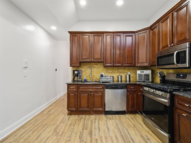 77 Crescent Ave Unit 8, Jersey City, NJ 07304 - kitchen featuring appliances with stainless steel finishes, a sink, decorative backsplash, light wood-type flooring, and vaulted ceiling