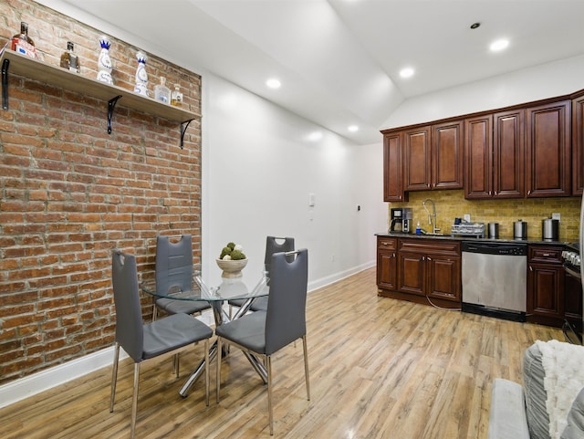 77 Crescent Ave Unit 8, Jersey City, NJ 07304 - kitchen with stainless steel dishwasher, dark countertops, light wood-style flooring, baseboards, and lofted ceiling