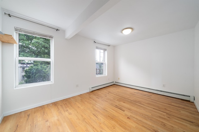 213 8th St, Jersey City, NJ 07302 - spare room with light wood-type flooring, a baseboard heating unit, and beamed ceiling